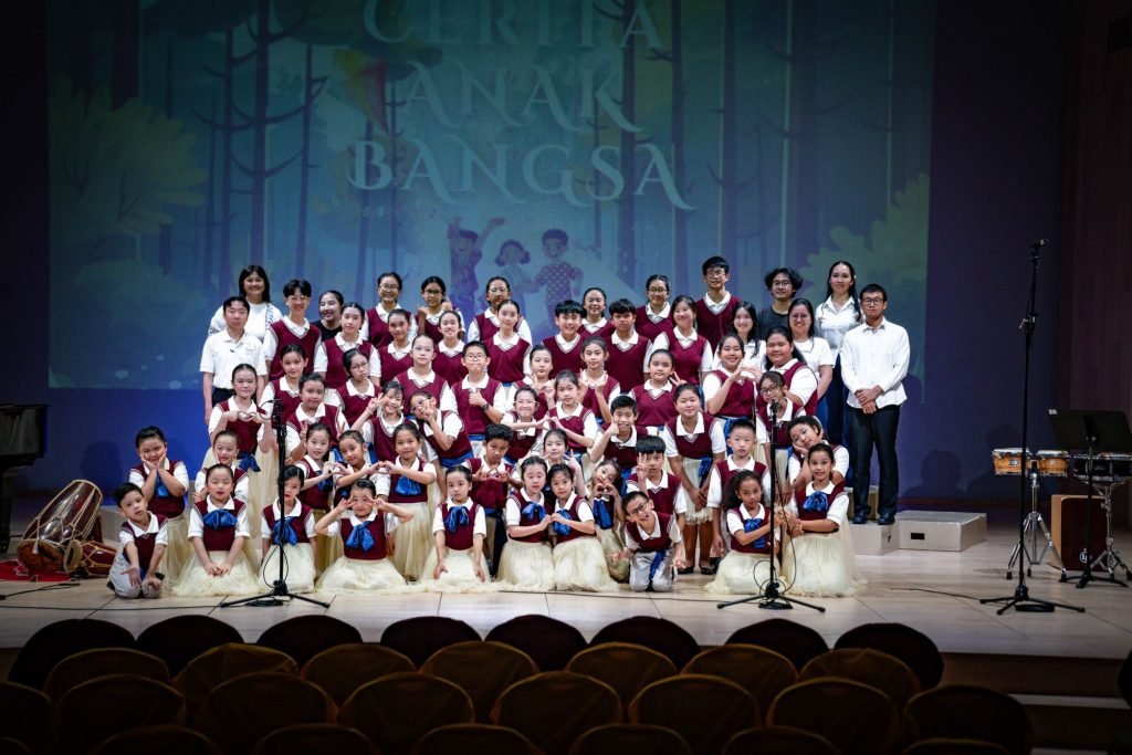 CMC students and teachers posing together on stage